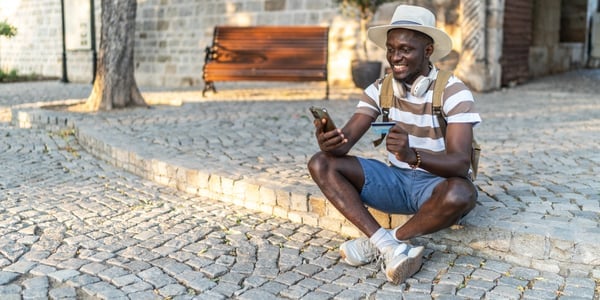 Tourist paying online with credit card and smartphone